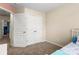 Neutral bedroom featuring plush carpet, a spacious closet, and cozy twin bed with blue accents at 424 River Park Rd, Belmont, NC 28012
