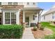 Inviting front porch with stone accents, bench seating, and well manicured bushes at 424 River Park Rd, Belmont, NC 28012