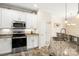 Beautiful kitchen with granite countertops, stainless steel appliances, and custom backsplash at 424 River Park Rd, Belmont, NC 28012