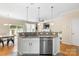 Well-appointed kitchen featuring a breakfast bar with granite countertops, stainless steel appliances, and modern lighting at 424 River Park Rd, Belmont, NC 28012