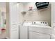 Practical laundry room with modern washer and dryer, shelving, and convenient storage options at 424 River Park Rd, Belmont, NC 28012
