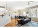 Bright living room with hardwood floors, open to the dining area and kitchen with breakfast bar at 424 River Park Rd, Belmont, NC 28012