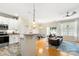 Bright open-concept living area featuring a modern kitchen, dining space, and a comfortable seating area with a blue rug at 424 River Park Rd, Belmont, NC 28012