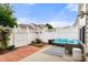 Charming patio area with red brick accents, a modern outdoor sofa, and privacy fencing at 424 River Park Rd, Belmont, NC 28012