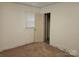 Bedroom with carpeted floors, and closet with built-in shelving at 4520 Bradbury Dr, Charlotte, NC 28209