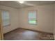 Bedroom with carpeted floors and natural light from two windows at 4520 Bradbury Dr, Charlotte, NC 28209