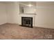 Spacious living room featuring a fireplace, mirror and carpet at 4520 Bradbury Dr, Charlotte, NC 28209