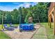 Enjoy outdoor fun with an above-ground pool, play set, and lounge chairs in the backyard at 454 N Eastway Dr, Troutman, NC 28166