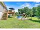 Spacious backyard featuring a deck, play set, above-ground pool, and lush green lawn at 454 N Eastway Dr, Troutman, NC 28166