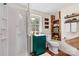 A charming bathroom with wood accents, a green vanity, and a glass door shower at 454 N Eastway Dr, Troutman, NC 28166
