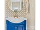 Charming bathroom vanity with a blue cabinet, decorative mirror, and modern fixtures at 454 N Eastway Dr, Troutman, NC 28166