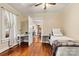 Cozy bedroom featuring hardwood floors, a desk with a chair, and a doorway to another room at 454 N Eastway Dr, Troutman, NC 28166