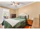 Bedroom with hardwood floors, green bedspread, and two wooden nightstands and a dresser at 454 N Eastway Dr, Troutman, NC 28166