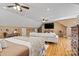 Bright bedroom with a large TV, cozy couch, wood floors, and neutral colors create a comfortable space at 454 N Eastway Dr, Troutman, NC 28166