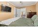Bedroom features hardwood floors, a TV, a dresser, and an open door leading to another room at 454 N Eastway Dr, Troutman, NC 28166