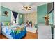 Colorful bedroom with hardwood floors, a window with curtains, and a white dresser at 454 N Eastway Dr, Troutman, NC 28166