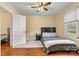 Bedroom with hardwood floors, a ceiling fan, a closet, a window, and a door leading to another room at 454 N Eastway Dr, Troutman, NC 28166