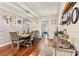 Dining area with hardwood floors, brick accent wall, modern lighting, and decor at 454 N Eastway Dr, Troutman, NC 28166