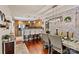Elegant dining room with brick accent wall, wood floors, and open access to the kitchen at 454 N Eastway Dr, Troutman, NC 28166