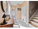 Welcoming entryway with tile floor, wooden accents, and a view into the bathroom and up the stairs at 454 N Eastway Dr, Troutman, NC 28166