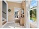 Bright hallway featuring tile floors, a view of the pool, and access to the laundry room at 454 N Eastway Dr, Troutman, NC 28166
