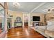 Bright living room boasts hardwood floors, a stone fireplace, neutral colors, and a smooth transition to dining area at 454 N Eastway Dr, Troutman, NC 28166