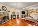 Spacious living room boasts hardwood floors, a stone fireplace, neutral colors, and plenty of natural light at 454 N Eastway Dr, Troutman, NC 28166