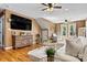 Inviting living room with a large TV, a cozy couch, hardwood floors, and neutral tones at 454 N Eastway Dr, Troutman, NC 28166