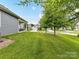 Expansive backyard featuring a lush lawn and mature trees, providing ample outdoor space at 505 Belle Grove Dr, Lake Wylie, SC 29710