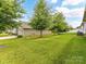 Lush backyard with well-maintained lawn and mature trees, offering a serene outdoor space at 505 Belle Grove Dr, Lake Wylie, SC 29710