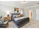 Comfortable bedroom with neutral tones, featuring a gray bed frame and a stylish accent chair at 505 Belle Grove Dr, Lake Wylie, SC 29710