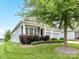 Attractive home featuring a covered front porch, green lawn and lush landscaping around the property at 505 Belle Grove Dr, Lake Wylie, SC 29710