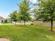 Well-manicured front yard with green lawn and mature trees enhance the home's curb appeal at 505 Belle Grove Dr, Lake Wylie, SC 29710