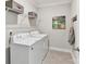 Functional laundry room with a side-by-side washer and dryer set and a storage shelf at 505 Belle Grove Dr, Lake Wylie, SC 29710