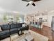 Bright living room featuring a gray sectional sofa, a glass coffee table, and an island with barstool seating at 505 Belle Grove Dr, Lake Wylie, SC 29710