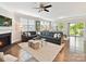 Spacious living room with a cozy fireplace, large windows, and stylish sectional sofa at 505 Belle Grove Dr, Lake Wylie, SC 29710