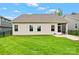 Expansive backyard featuring lush green grass, a screened-in porch, and well-maintained landscaping at 5079 Skyfest Dr, Charlotte, NC 28215