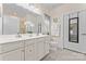 Bright bathroom with double vanity, tile flooring, and a large mirror with modern lighting at 5079 Skyfest Dr, Charlotte, NC 28215