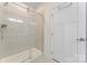 Tiled shower with a glass door and a white door at 5079 Skyfest Dr, Charlotte, NC 28215