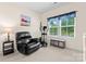 Cozy bedroom with a comfortable recliner, an elliptical, and a window view of the outdoors at 5079 Skyfest Dr, Charlotte, NC 28215