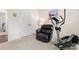 Carpeted bedroom with a comfortable recliner, an elliptical, and a double door closet for ample storage at 5079 Skyfest Dr, Charlotte, NC 28215