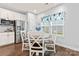 Dining area with stainless steel refrigerator, white cabinets, and decorative blue-themed decor at 5079 Skyfest Dr, Charlotte, NC 28215