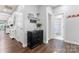 Inviting hallway with dark hardwood floors and neutral paint, leading to other areas of the home at 5079 Skyfest Dr, Charlotte, NC 28215