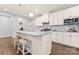 Bright kitchen with white cabinets, stainless steel appliances, granite countertops, and hardwood floors at 5079 Skyfest Dr, Charlotte, NC 28215