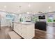 Open concept kitchen with granite island, stainless steel appliances, and view to living and dining area at 5079 Skyfest Dr, Charlotte, NC 28215