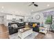 Open-concept living room with a large sectional sofa, hardwood floors, and lots of natural light at 5079 Skyfest Dr, Charlotte, NC 28215