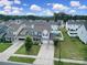 Aerial view of a beautiful blue two-story home with a two-car garage and a well-manicured lawn at 5125 Thomasville Dr, Belmont, NC 28012