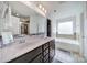 Bright bathroom featuring double sinks, dark cabinets, soaking tub and tiled floors at 5125 Thomasville Dr, Belmont, NC 28012