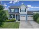 Charming two-story home featuring a covered porch, well-maintained lawn, and a convenient two-car garage at 5125 Thomasville Dr, Belmont, NC 28012