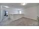 Upstairs hallway featuring neutral carpeting and a view into an adjacent bedroom at 5125 Thomasville Dr, Belmont, NC 28012